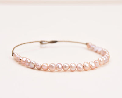 the crown anklet in blush pearls closeup with a white background