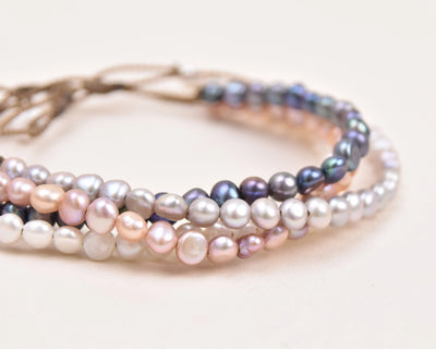 the crown anklet in all four colors of pearls in a stack with a white background