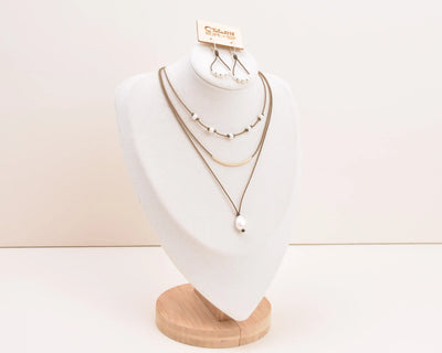 Dripping in Pearls necklace stack in white on bust with earrings and white background