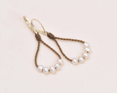 dainty pearl earrings in white layout on white background