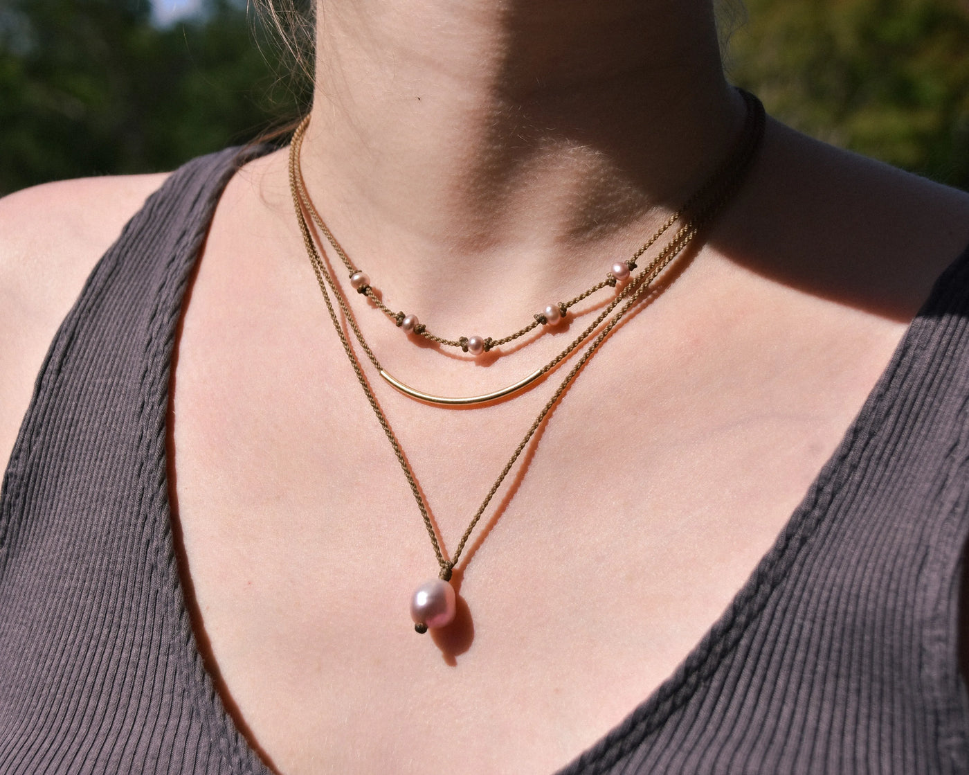 Dripping in Pearls necklace stack in blush on model closeup