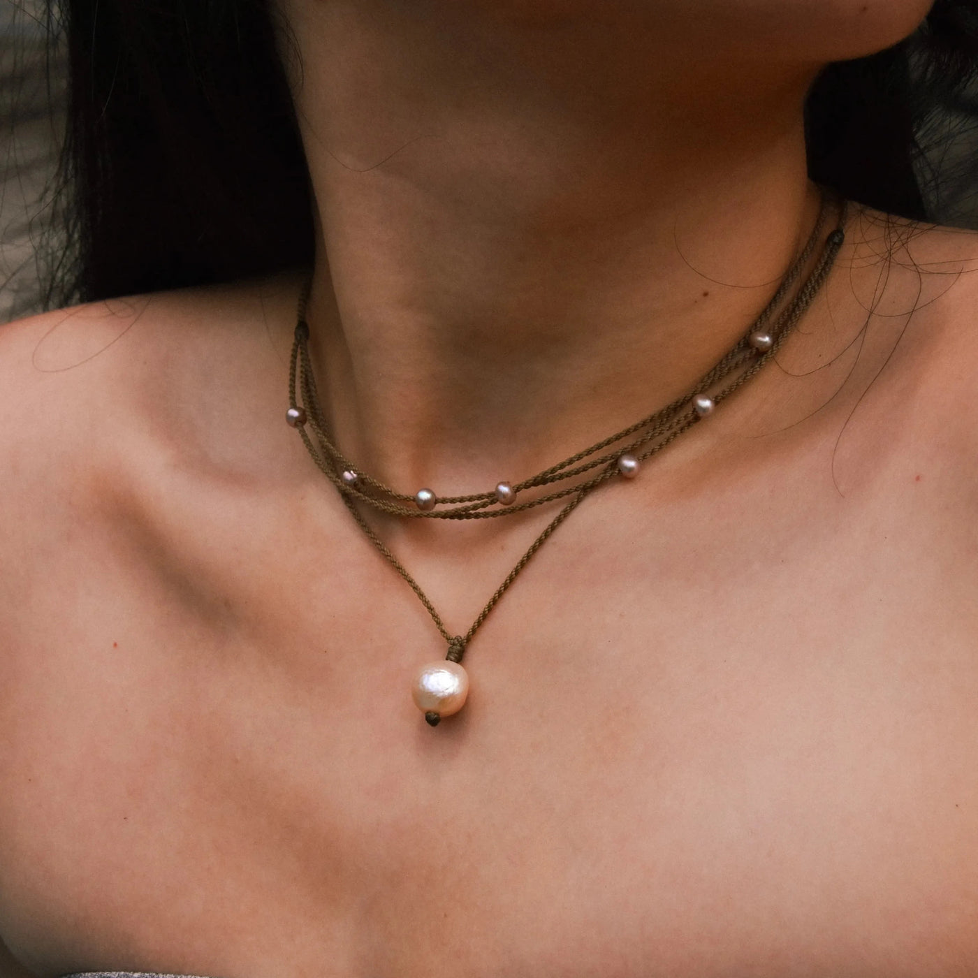 Pearl Drop Necklace in Peach on model paired with blush riptide necklace