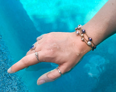 Tula Blue's Journey Bracelet in mixed pearl on model wrist in water