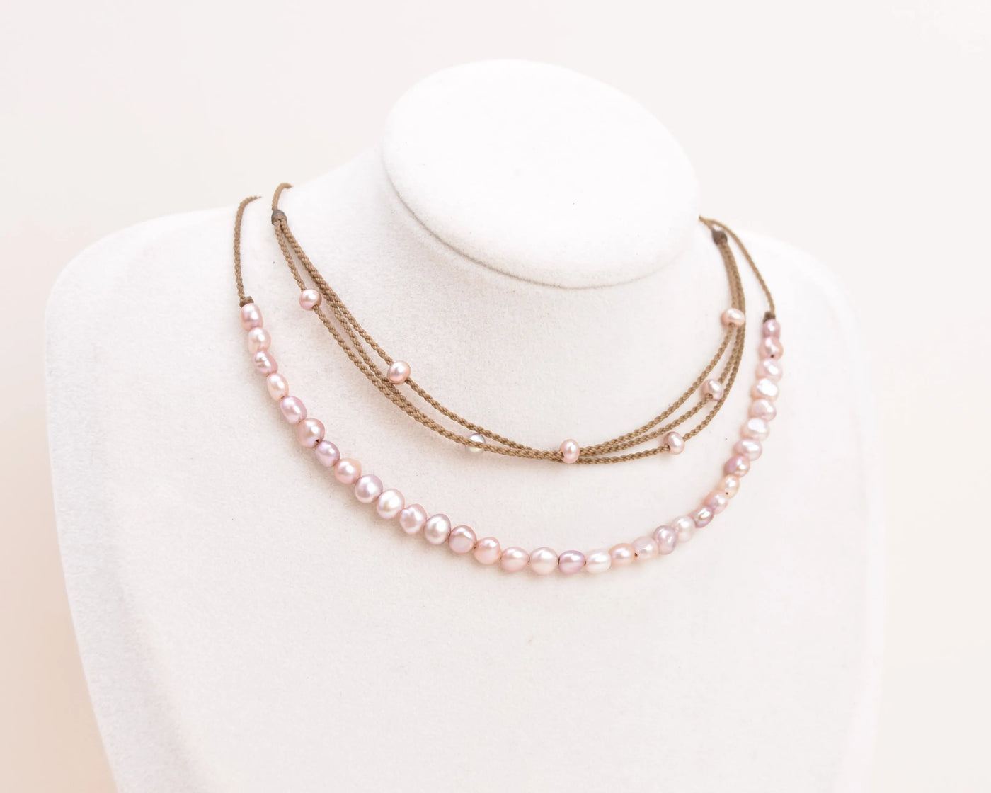 blush pearl crown necklace and blush pearl riptide necklace on bust