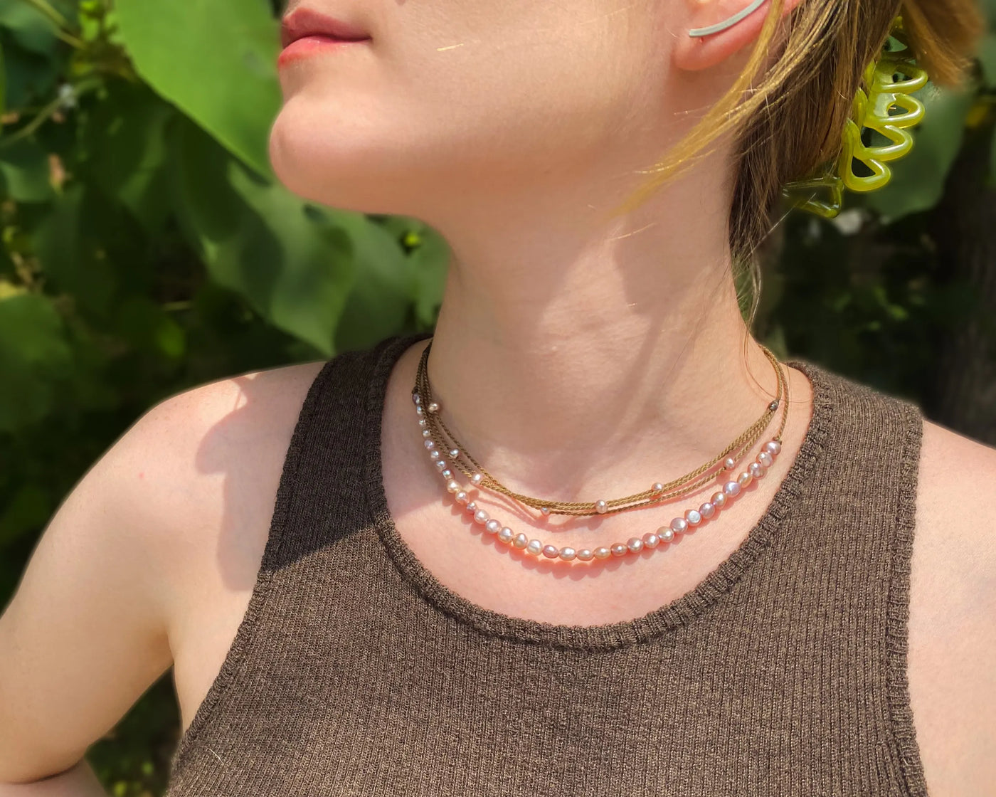 blush pearl crown necklace and blush pearl riptide necklace on model