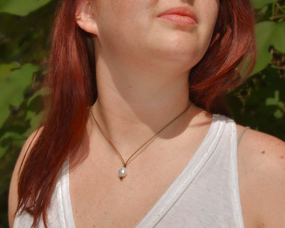 Pearl drop necklace in white on model