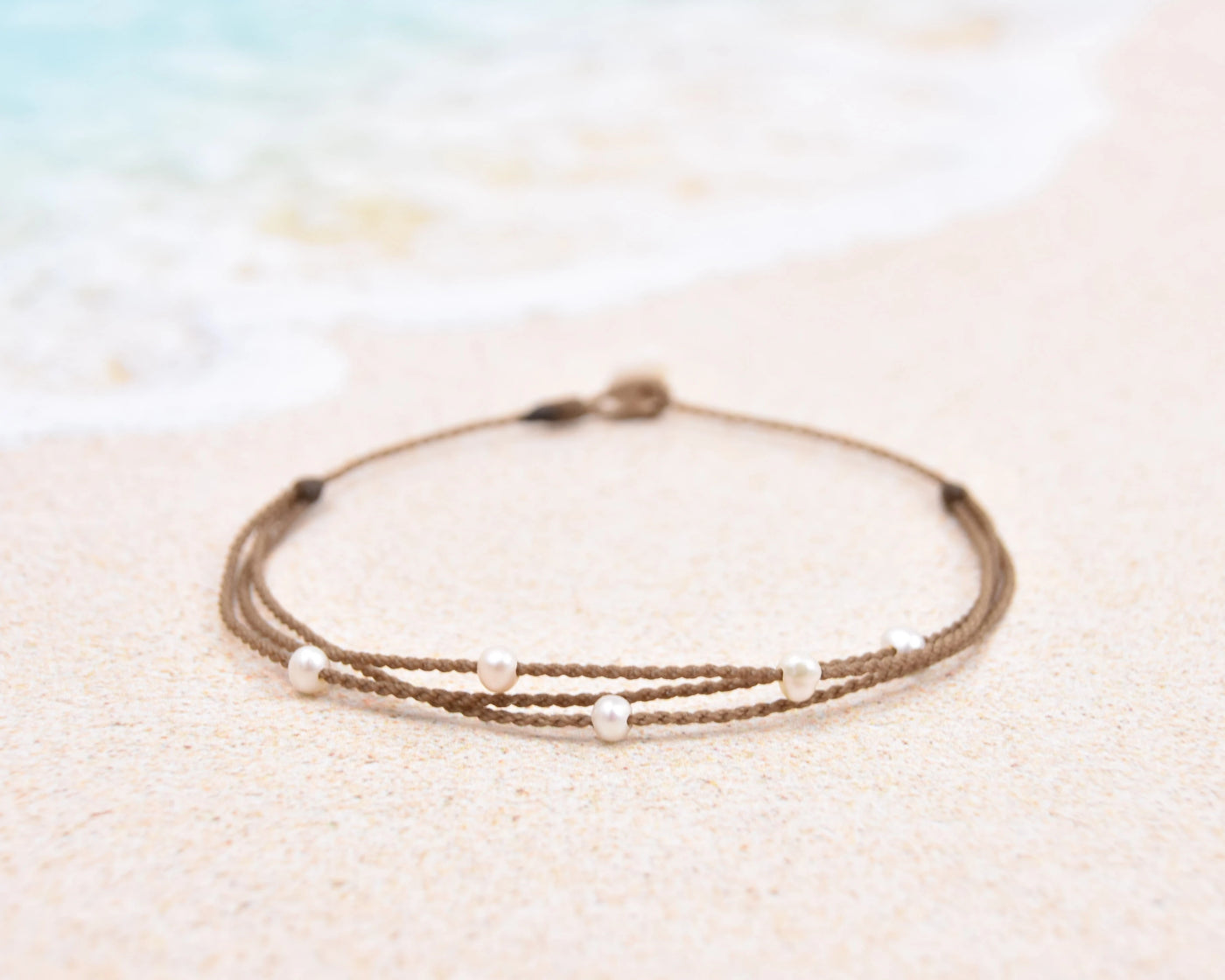 Tula Blue's waterproof Riptide anklet in white pearls. All the drama of a stack in one perfect anklet.