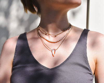 Rosy Aura Necklace Stack in blush on model with white background