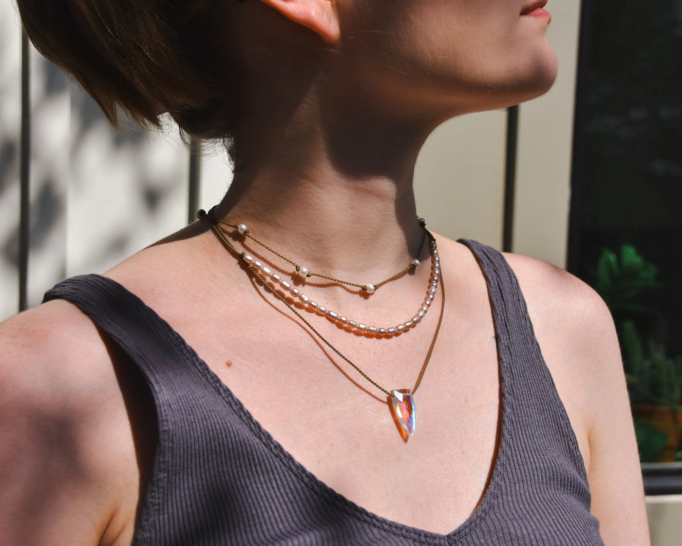 Rosy Aura Necklace Stack in white on model with white and black background 