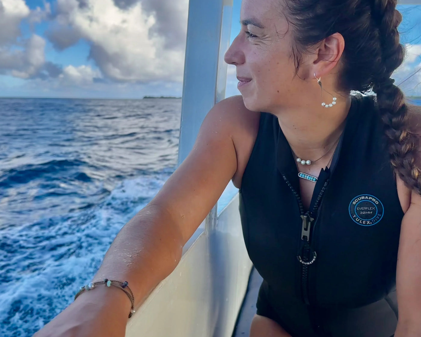 Seven Seas bracelet on PADI scuba diver on boat looking out over the ocean