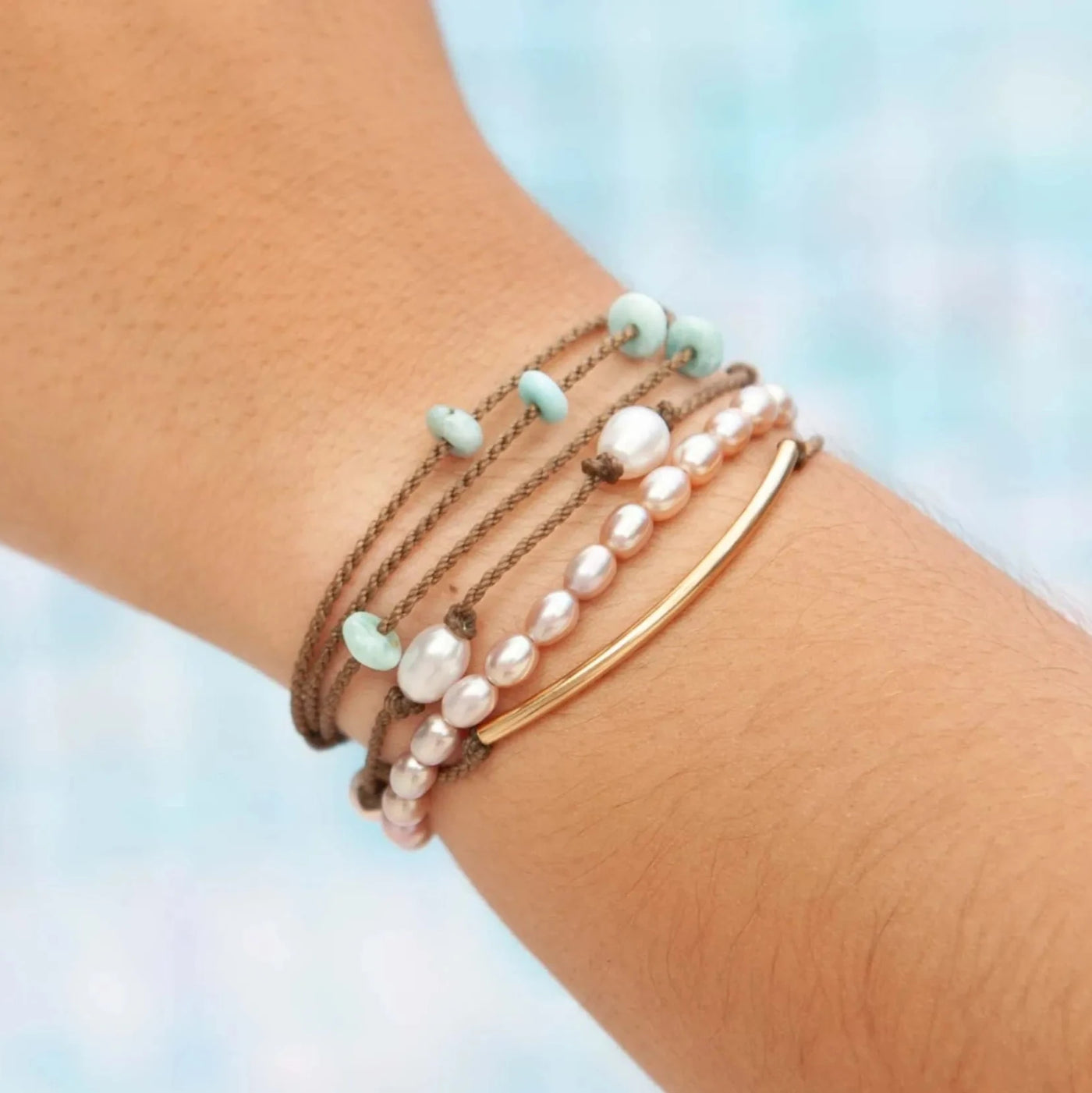 sunlit lagoon bracelet stack on model with blue background