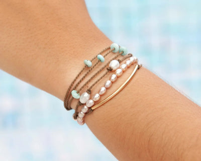 sunlit lagoon bracelet stack on model with blue background